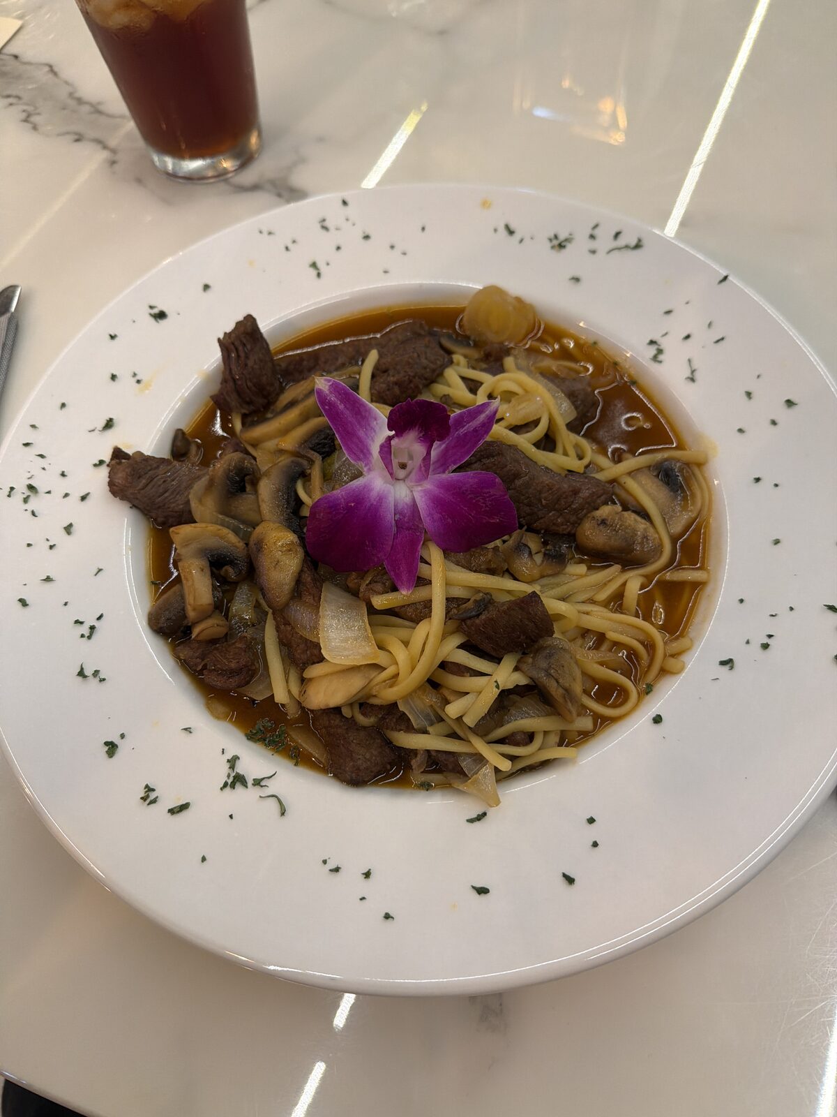 Beef noodle soup with mushrooms and onions